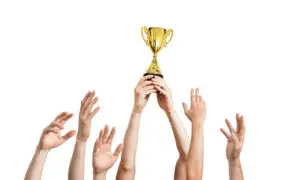 Sports Trophies Online. Winner is holding trophy in hands. Isolated on white background. Expert Engraving,