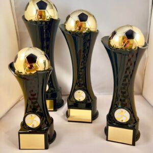 4 football trophiesGold plastic football in golden black cone support with black marble base